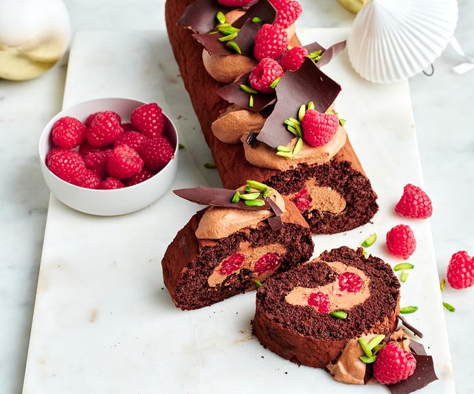 Chocolate Yule log with chocolate cream and fresh raspberries.